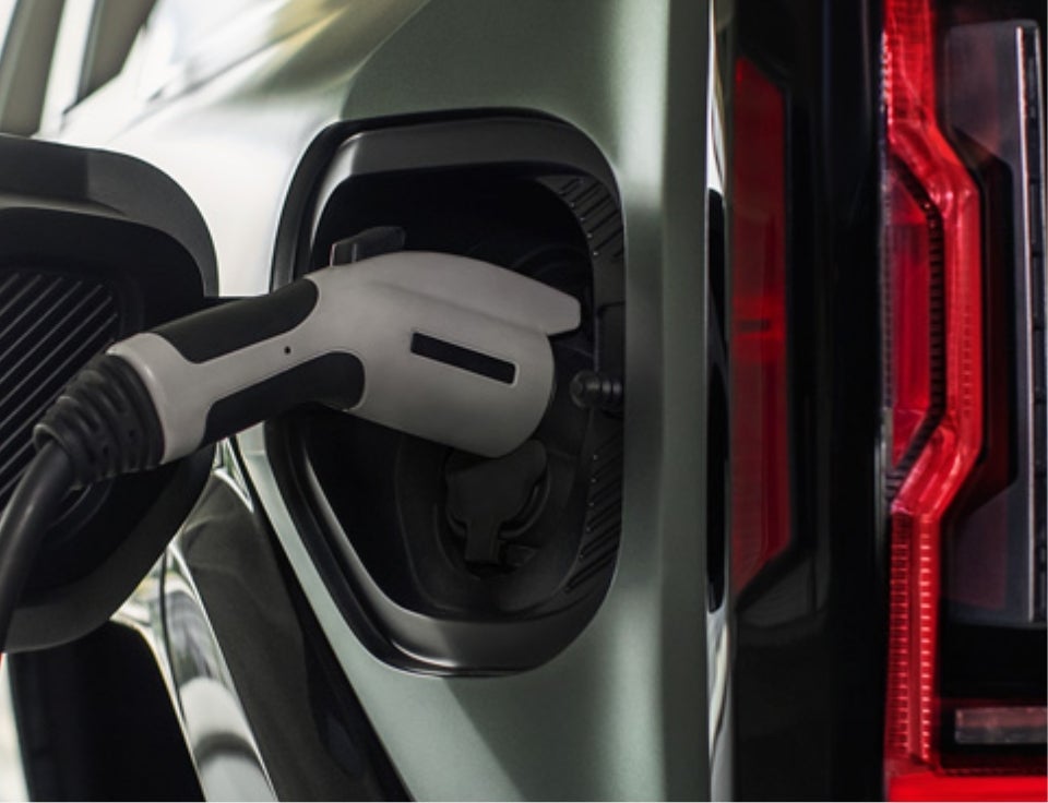 Close up of charging port with charger plugged in on a GMC Hummer EV SUV - Escamilla GMC in Hebbronville TX
